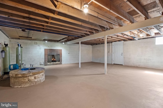 unfinished basement featuring a fireplace