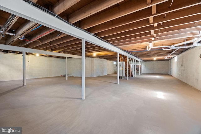 unfinished below grade area featuring water heater