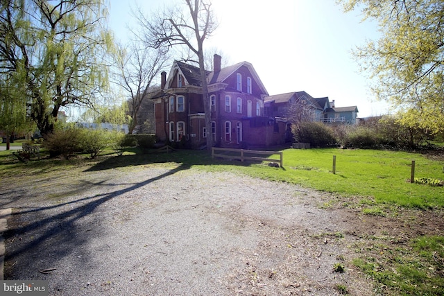 exterior space featuring a yard and a chimney