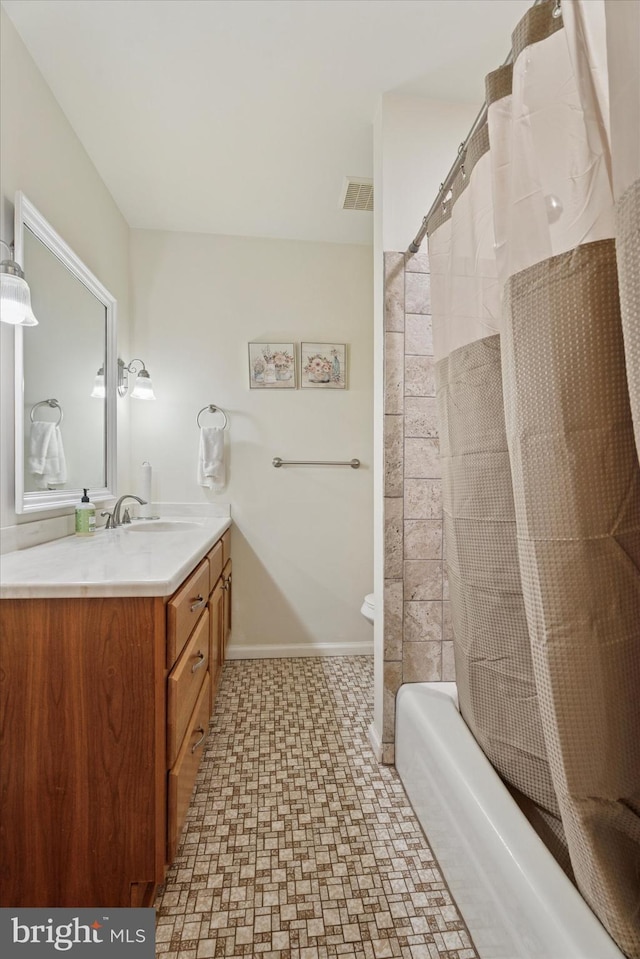 full bath featuring vanity, tile patterned floors, shower / bath combination with curtain, baseboards, and visible vents