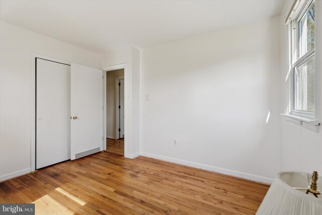 unfurnished bedroom with light wood-style floors and baseboards