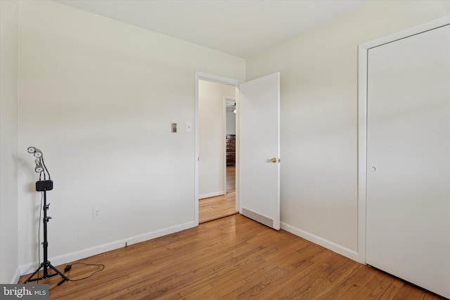 unfurnished bedroom featuring baseboards and wood finished floors