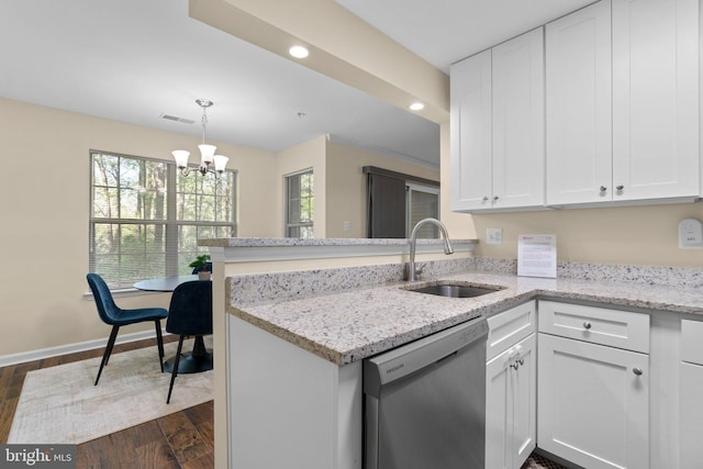 kitchen with dark wood-style flooring, visible vents, dishwasher, a sink, and white cabinetry