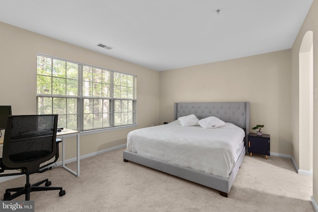 carpeted bedroom featuring baseboards and visible vents