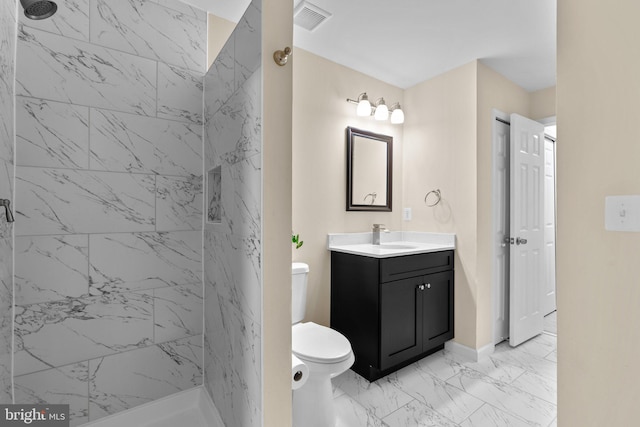 full bathroom featuring visible vents, tiled shower, marble finish floor, and vanity