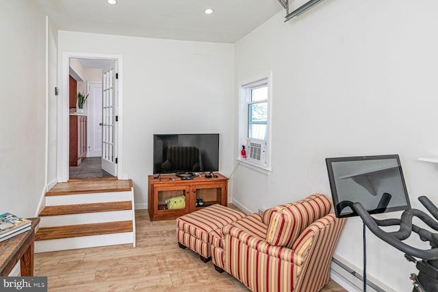 living area with light wood-style floors, recessed lighting, and baseboard heating