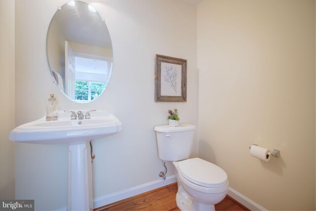 15648 Avocet Loop, Woodbridge, VA 22191 - half bathroom with baseboards, wood finished floors, and toilet