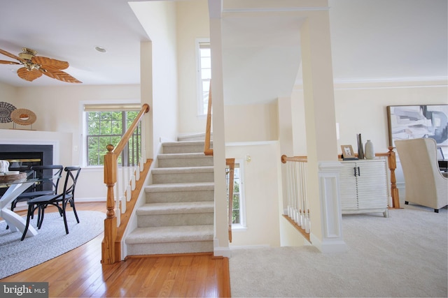15648 Avocet Loop, Woodbridge, VA 22191 - stairs with baseboards, a ceiling fan, a multi sided fireplace, and wood finished floors