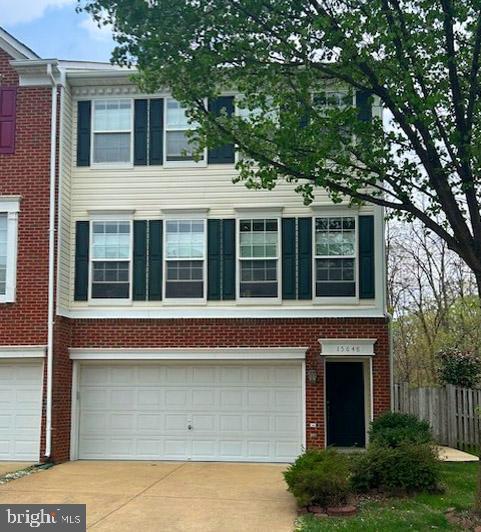 15648 Avocet Loop, Woodbridge, VA 22191 - view of property with brick siding, an attached garage, fence, and driveway