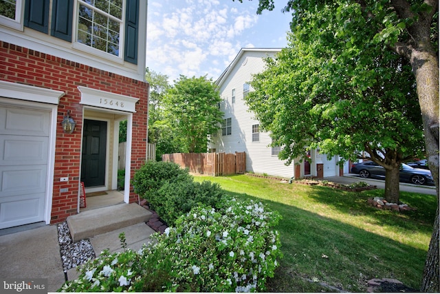15648 Avocet Loop, Woodbridge, VA 22191 - exterior space featuring a garage and fence