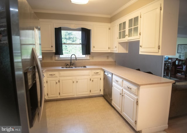kitchen with a sink, light countertops, white cabinets, ornamental molding, and stainless steel appliances