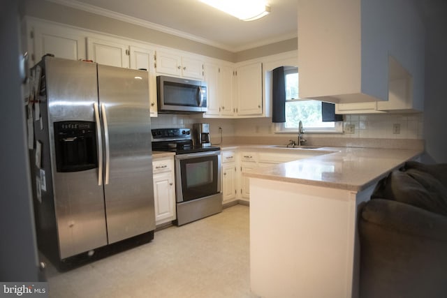 kitchen featuring crown molding, a peninsula, light floors, a sink, and appliances with stainless steel finishes