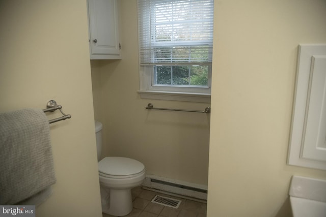 bathroom featuring toilet, visible vents, tile patterned flooring, and a baseboard radiator