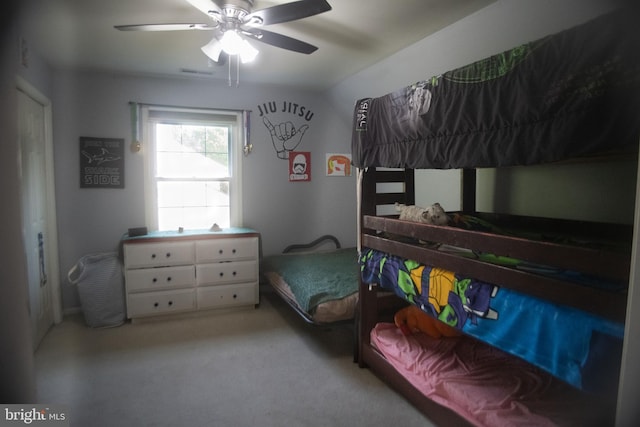 carpeted bedroom featuring ceiling fan and visible vents