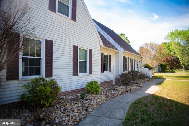 view of side of home with a lawn