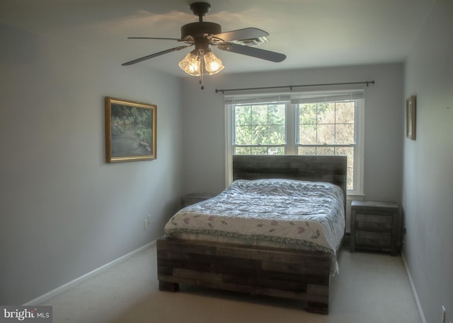 carpeted bedroom with baseboards and a ceiling fan