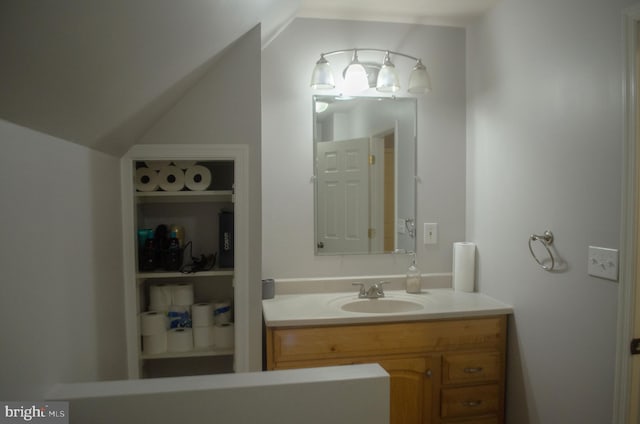 bathroom with vanity and vaulted ceiling