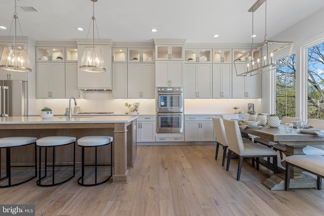 238 N Aberdeen Ave Lot 2, Wayne, PA 19087 - kitchen featuring light wood-style flooring, a breakfast bar area, stainless steel appliances, light countertops, and visible vents