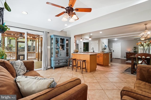living room featuring recessed lighting, vaulted ceiling, light tile patterned floors, and ceiling fan with notable chandelier