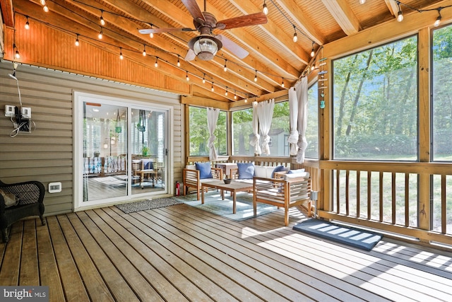 sunroom with ceiling fan, an outdoor living space, rail lighting, and beam ceiling