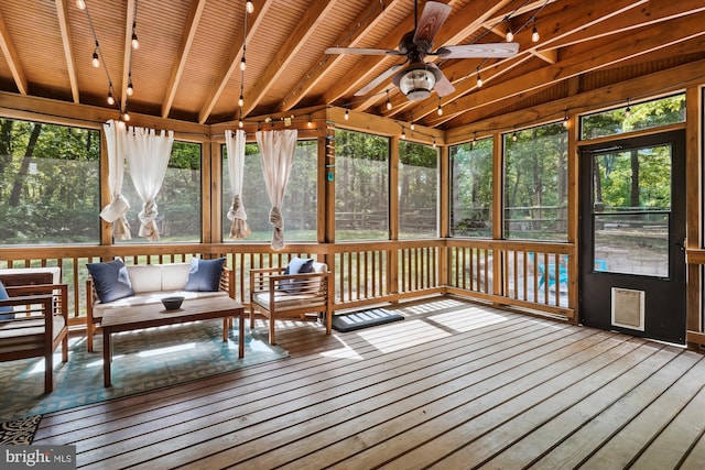 sunroom / solarium featuring an outdoor living space, ceiling fan, and beam ceiling