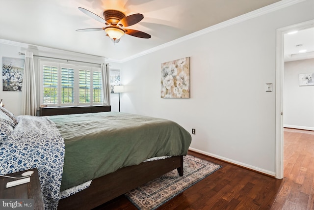 bedroom featuring crown molding, baseboards, ceiling fan, and wood finished floors