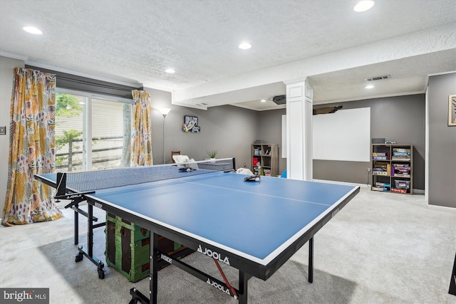 game room featuring a textured ceiling, light colored carpet, visible vents, ornamental molding, and recessed lighting