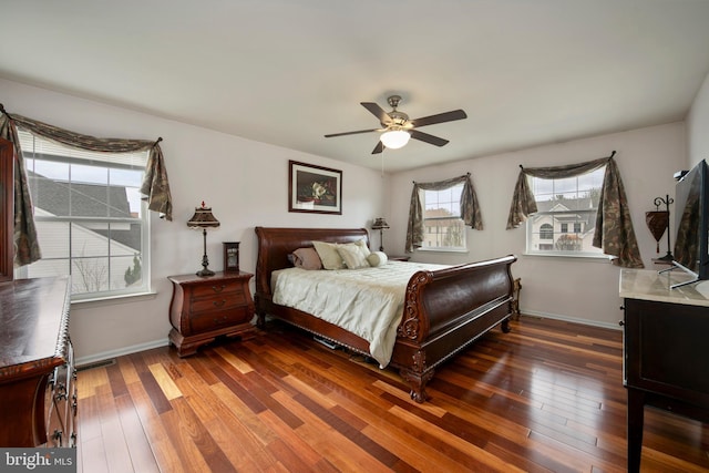 bedroom featuring baseboards, a ceiling fan, and hardwood / wood-style floors