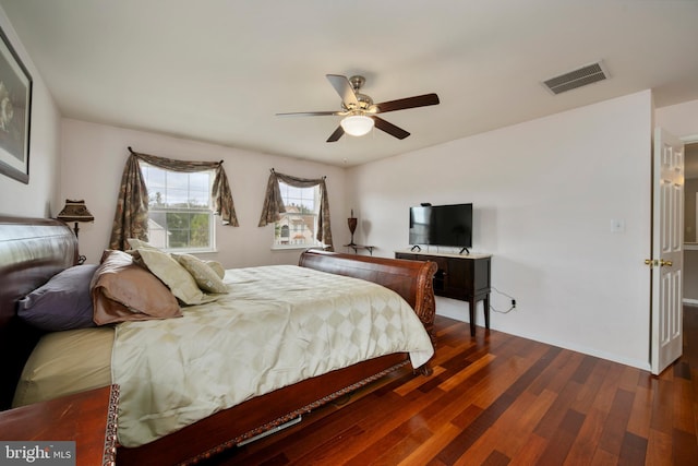 bedroom featuring ceiling fan, visible vents, and dark wood-style flooring