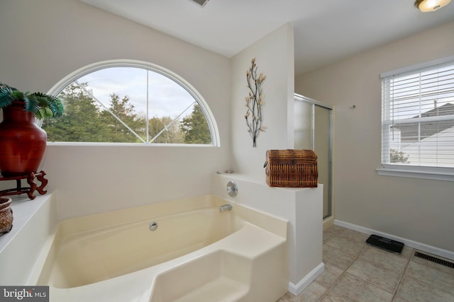 full bathroom featuring tile patterned floors, a garden tub, visible vents, and a shower stall