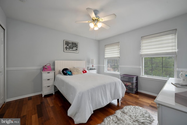 bedroom featuring a ceiling fan, baseboards, and dark wood-style flooring