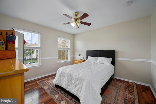 bedroom with baseboards, a ceiling fan, and wood finished floors