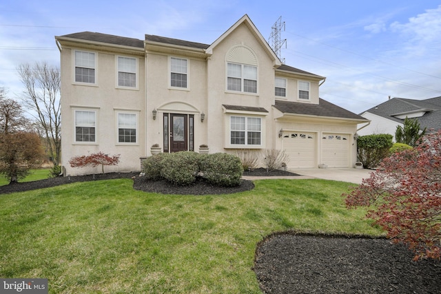 view of front of home featuring a garage, driveway, a front yard, and stucco siding