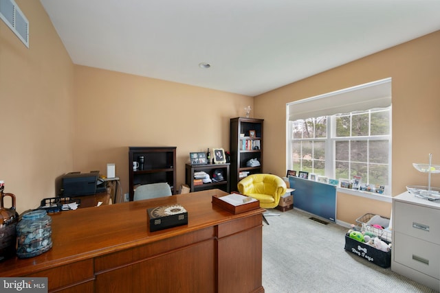 home office featuring baseboards, visible vents, and light colored carpet