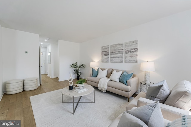 living room with recessed lighting, light wood finished floors, and baseboards