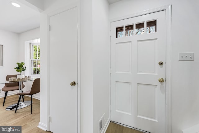 interior space featuring light wood-type flooring, baseboards, and visible vents