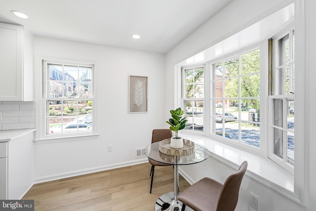 dining area featuring light wood finished floors, visible vents, a wealth of natural light, and recessed lighting