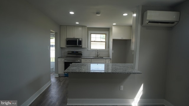 3220 Byberry Rd, Philadelphia, PA 19154 - kitchen featuring stainless steel appliances, an AC wall unit, a sink, baseboards, and tasteful backsplash