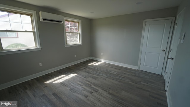 3220 Byberry Rd, Philadelphia, PA 19154 - unfurnished room featuring a wall unit AC, dark wood finished floors, and baseboards