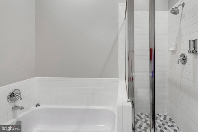full bathroom featuring a bath and a stall shower