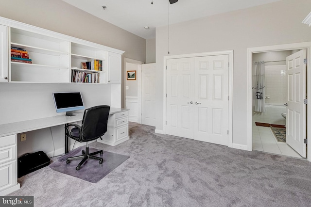 home office featuring ceiling fan and light carpet