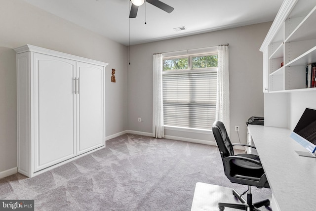 office area with baseboards, a ceiling fan, light colored carpet, and visible vents