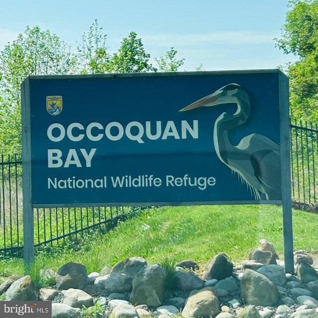 community / neighborhood sign with fence