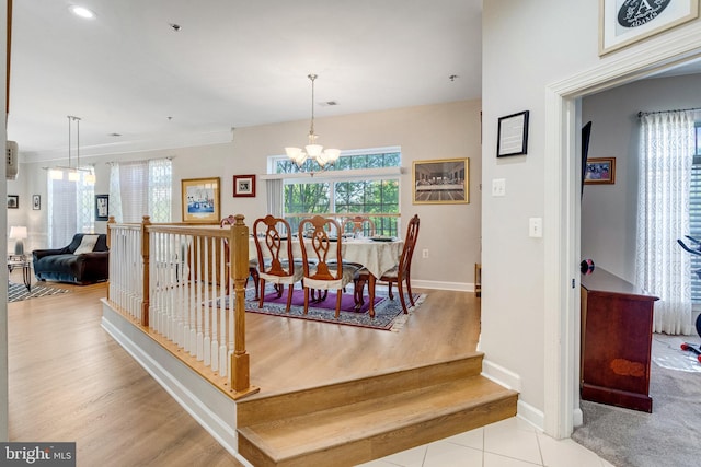 dining room featuring baseboards, recessed lighting, wood finished floors, and an inviting chandelier