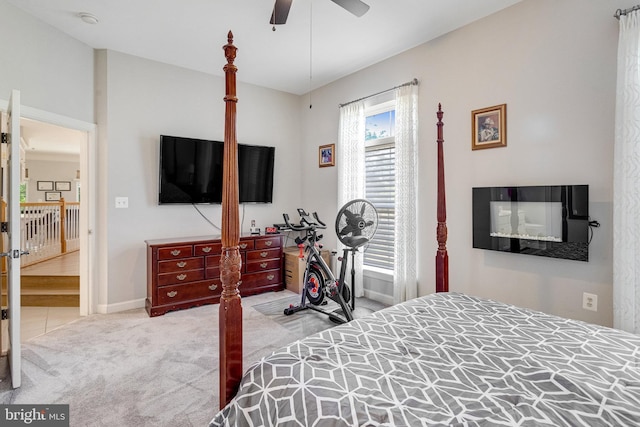 carpeted bedroom featuring a ceiling fan and baseboards