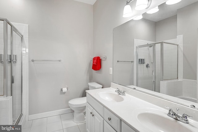 full bath featuring tile patterned floors, a shower stall, and a sink
