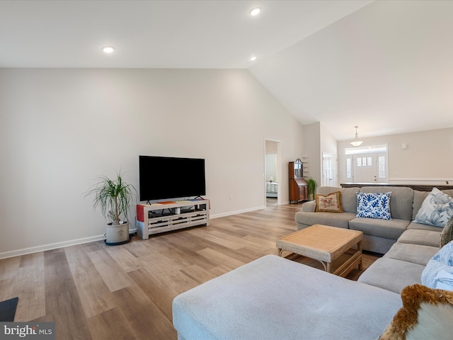 living area featuring wood finished floors, recessed lighting, high vaulted ceiling, and baseboards