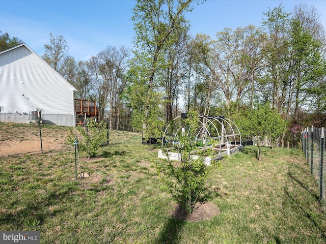 view of yard with fence and a vegetable garden