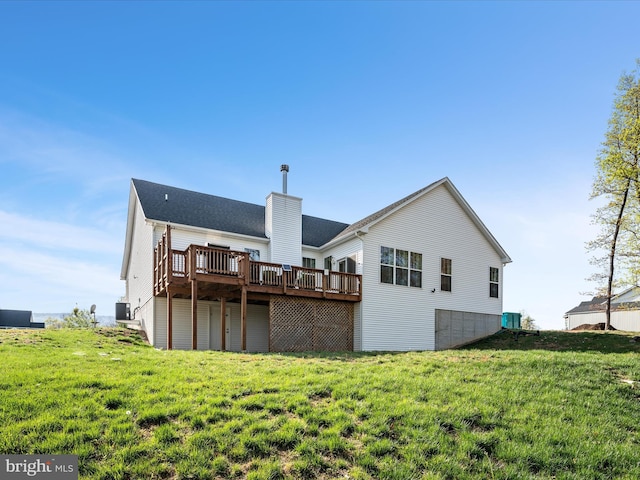rear view of property with a deck, central AC, a yard, and a chimney