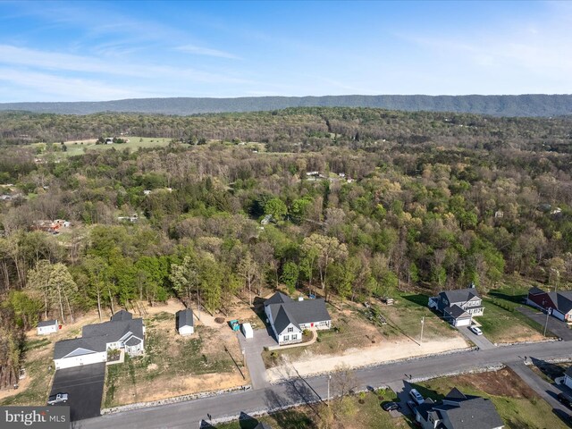 birds eye view of property featuring a view of trees